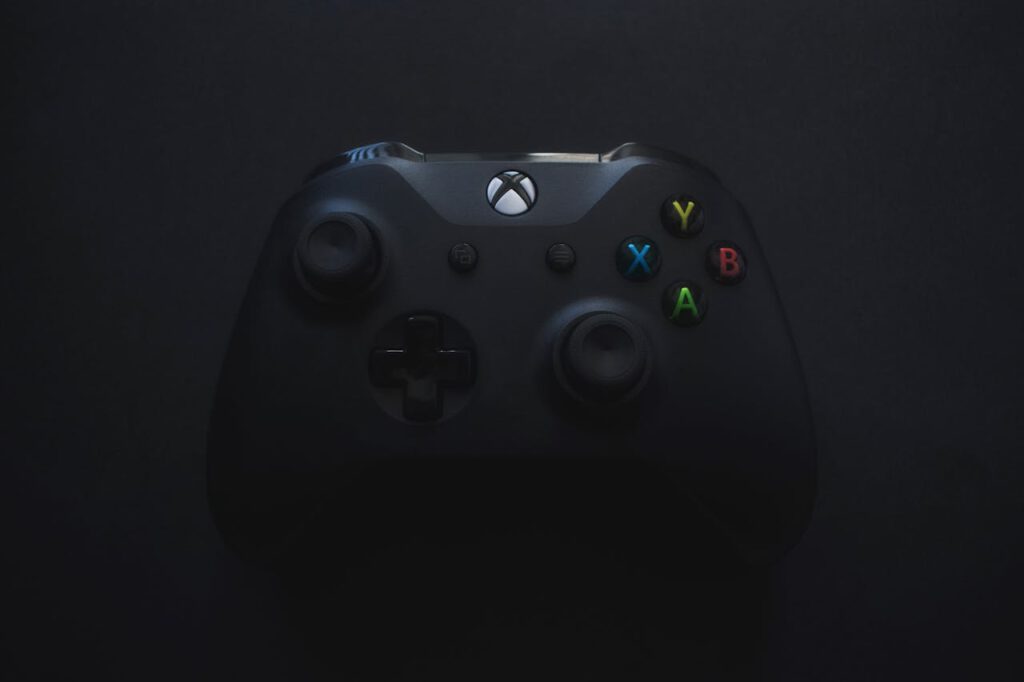 Xbox controller illuminated against a dark background, perfect for gaming themes.